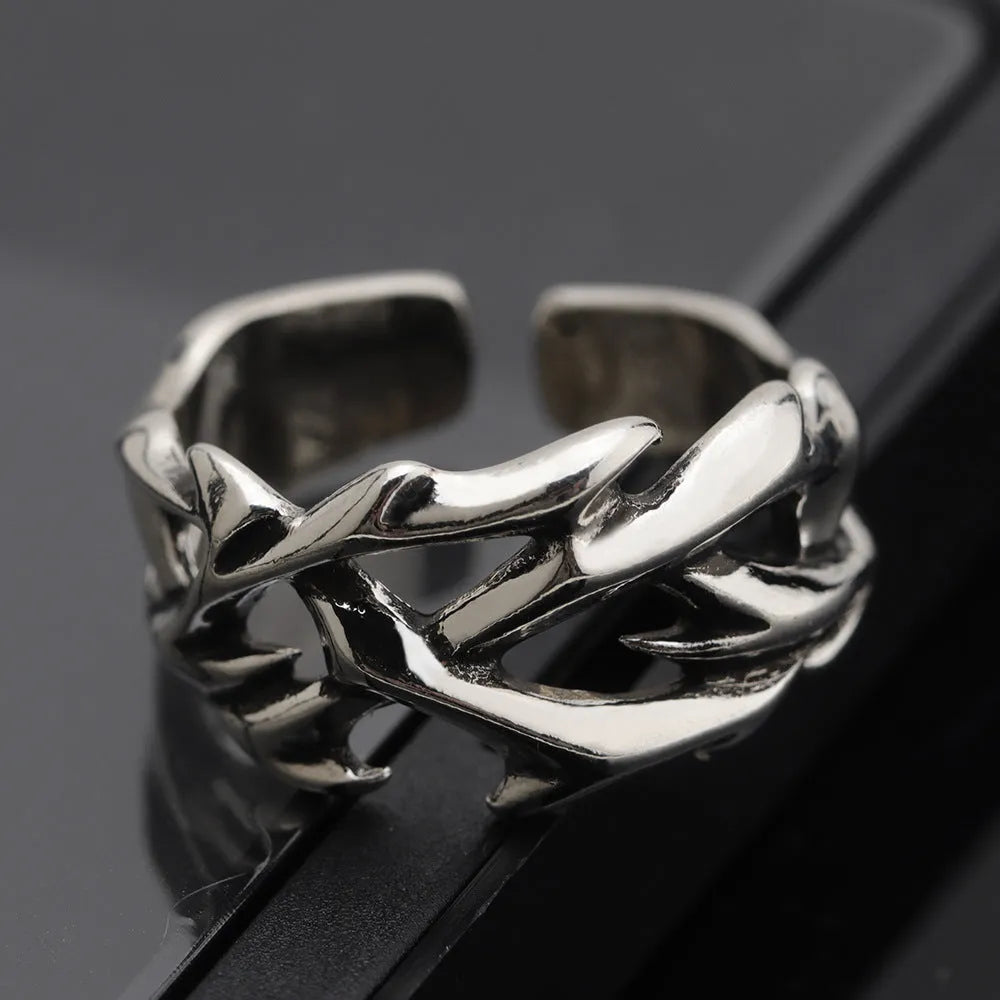 Copper men's ring with geometric thorn and flower design on an adjustable band