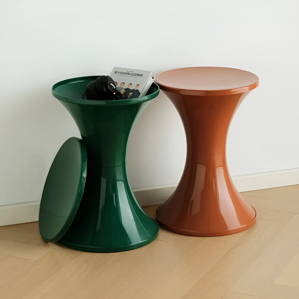 Green plastic hourglass-style shoe changing stool on a wooden floor.