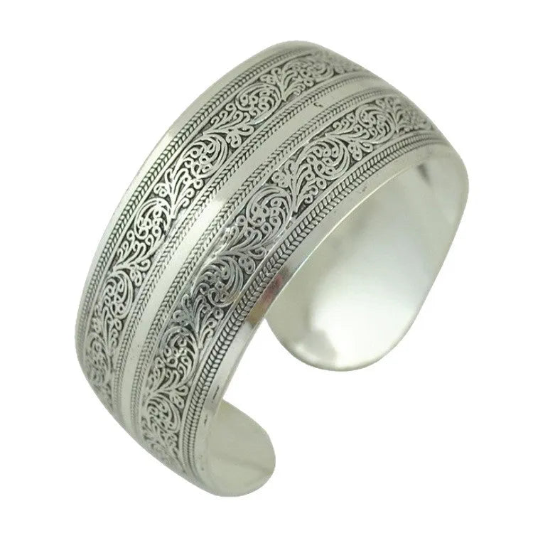 Openwork ethnic bracelet with carved Miao silver finish showing elephant design detail on wrist.