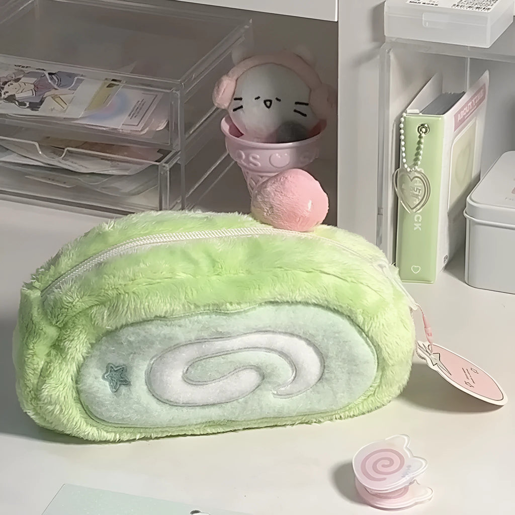 Honeydew roll plush velvet pencil case in Swiss roll cake colour on a desk.