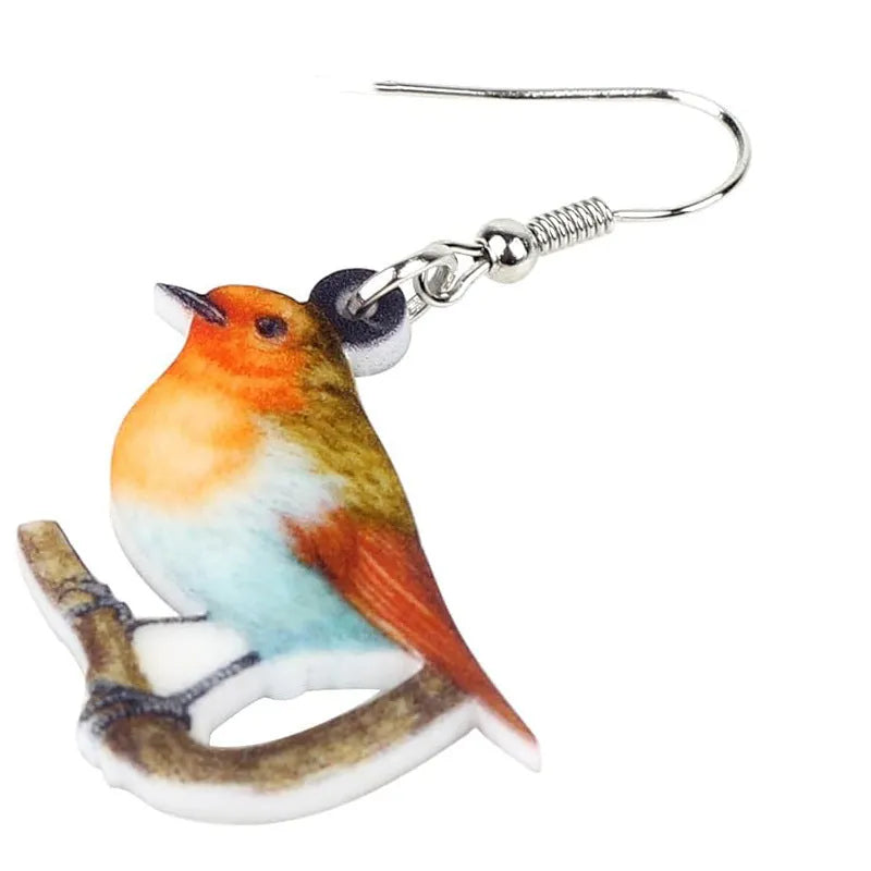 Blue, yellow, and white titmouse bird acrylic pendant drop earrings on a white background.