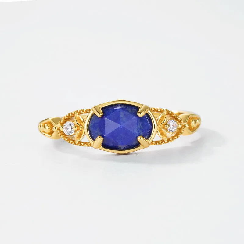 Elliptical silver alloy ring with a natural blue lapis lazuli gemstone for women.