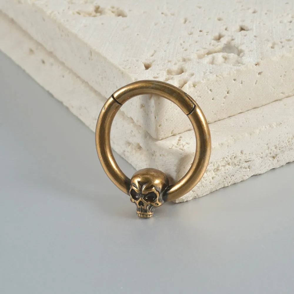 Copper punk earring with antique silver ghost head charm.