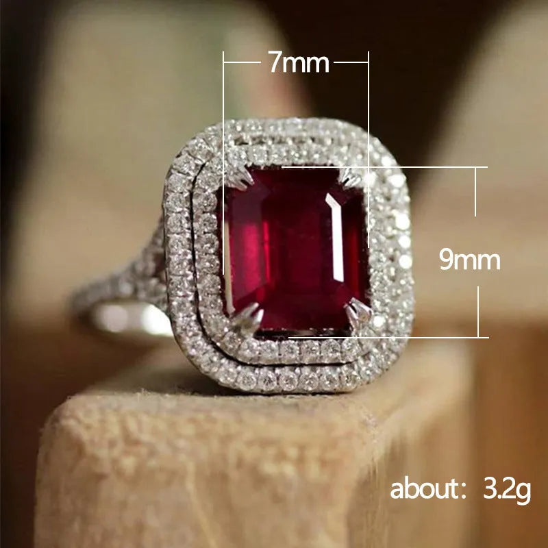 Women's geometric copper ring with a square red rhinestone on a hand.