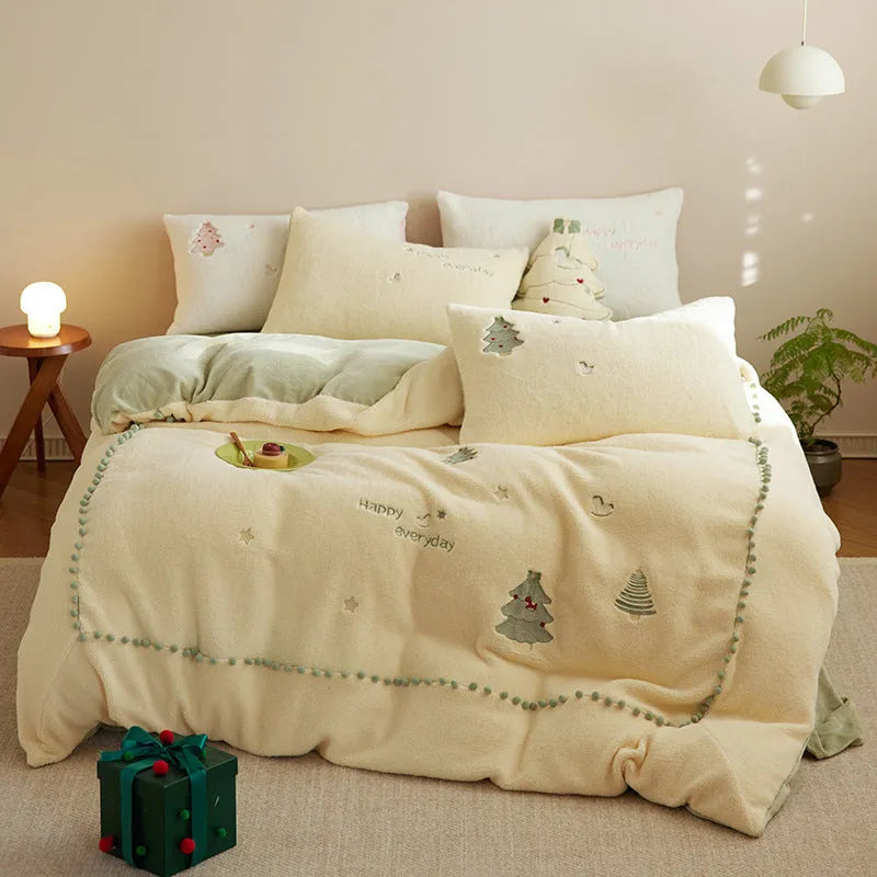 Milk fibre four-piece bedding set with green and pink Christmas tree designs on quilt cover and pillowcases.