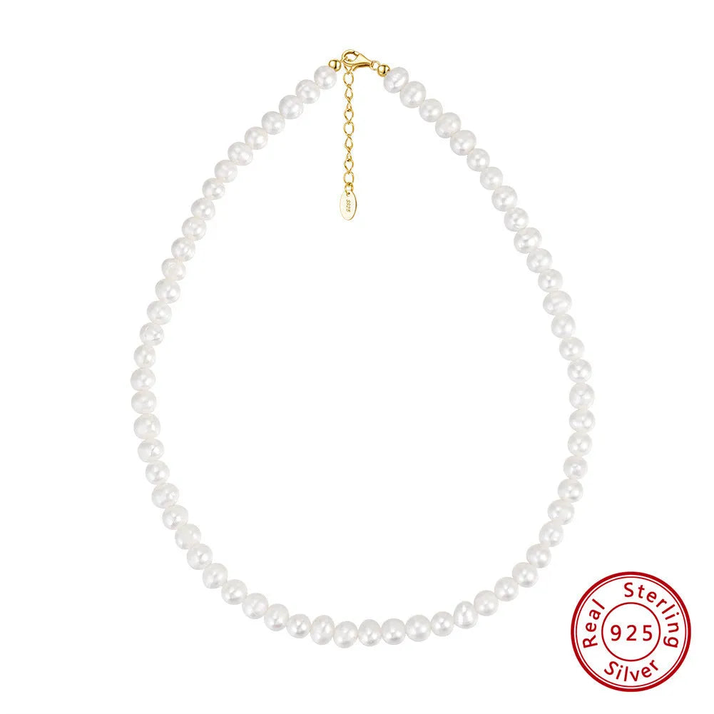 Close-up of a silver adjustable necklace with a single natural freshwater pearl pendant.