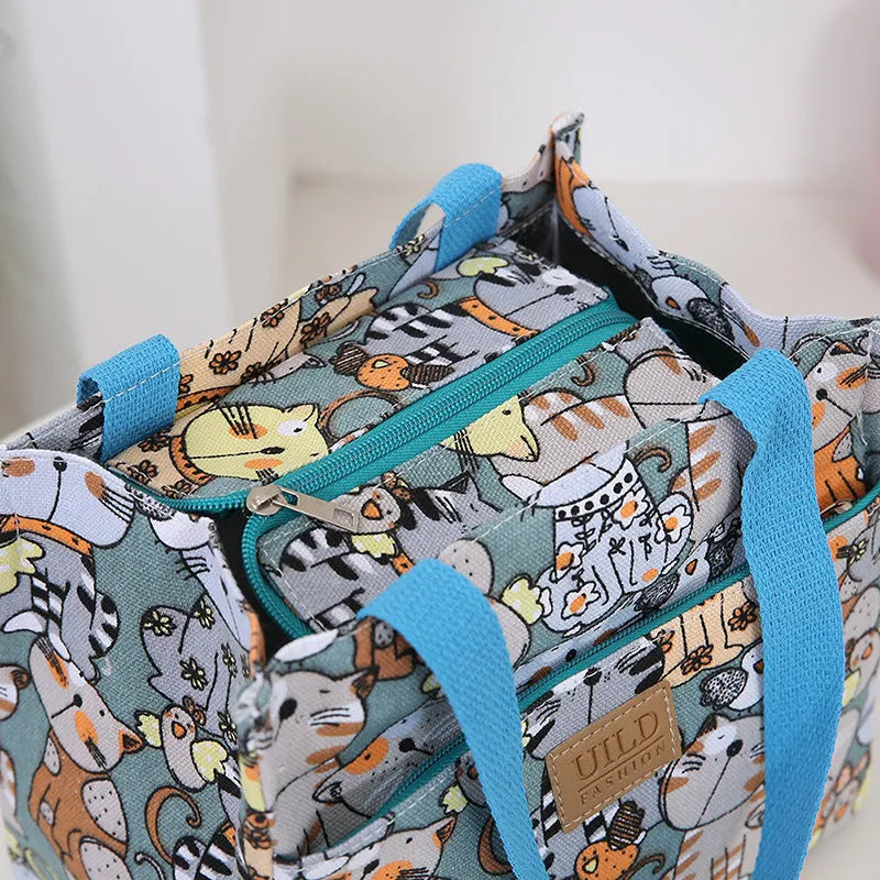 Women's large printed canvas tote bag with aluminium handles in a choice of floral and cat designs.