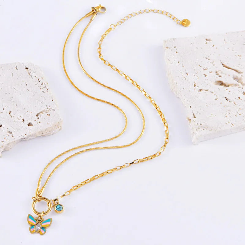 Gold tone epoxy butterfly pendant necklace and bracelet set with snake bone chain.
