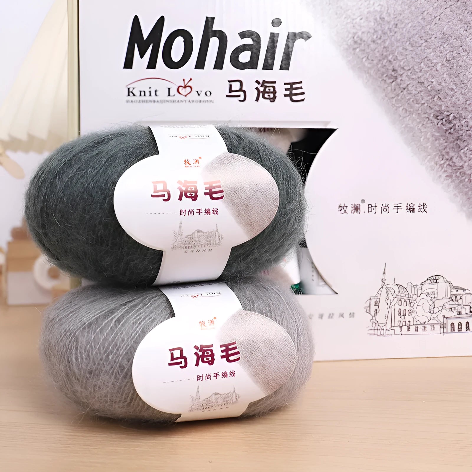 Single 100g ball of mohair yarn in a chosen colour next to a hand-woven light grey scarf sample.