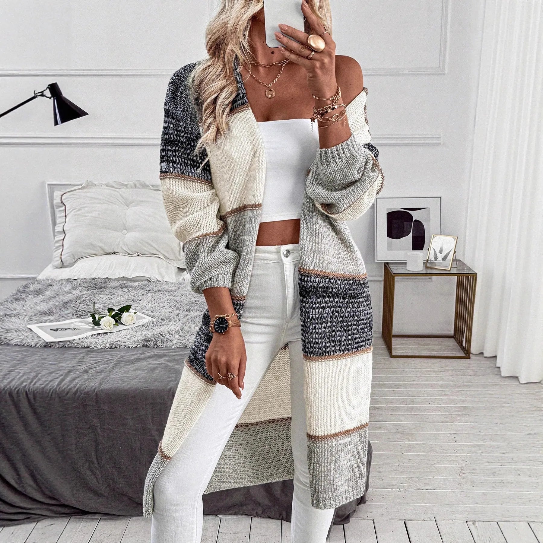 Grey stripe knitted long cardigan for women, loose fit with long sleeves on a hanger.