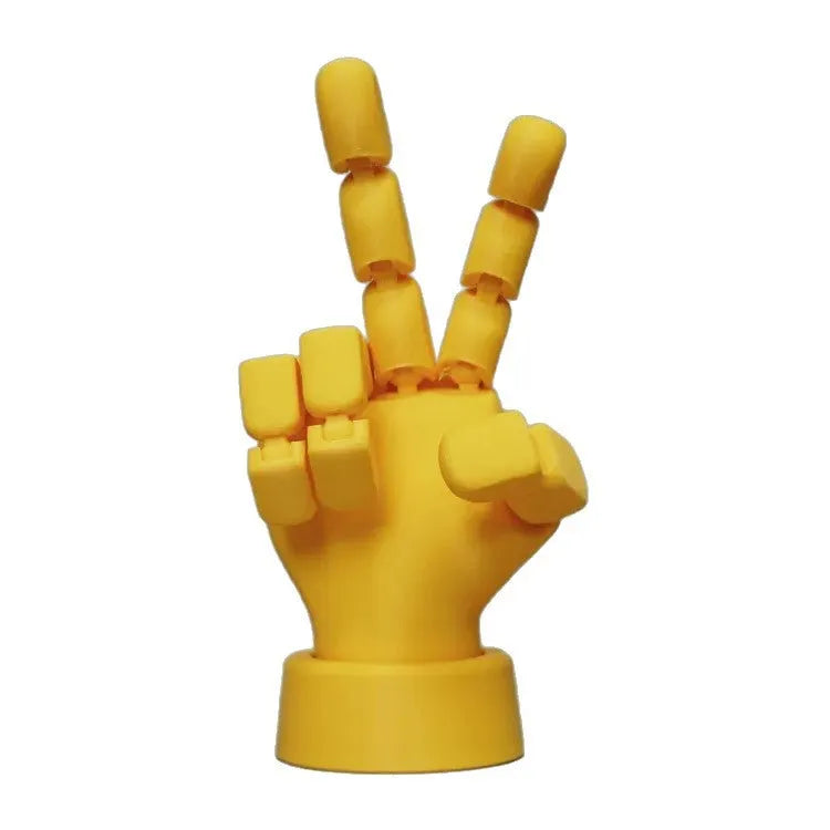 Yellow movable joint hand prop figurine with articulated fingers on a neutral background.