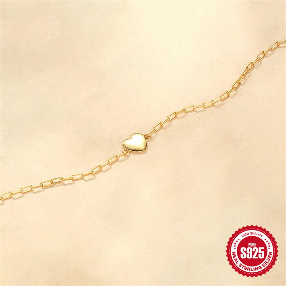 S925 sterling silver women's bracelet with glossy gold tone heart charm and lobster clasp closure