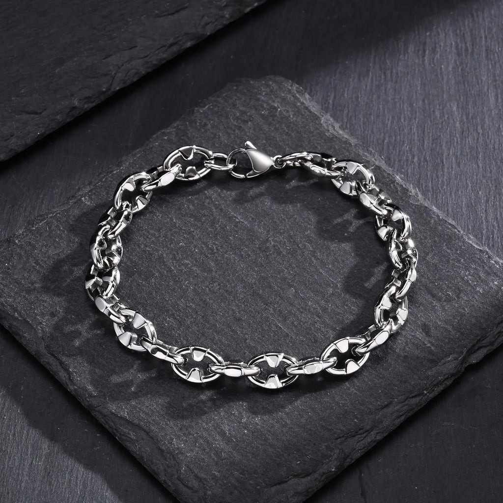 Close-up of a thick stainless steel geometric chain bracelet for men on a wrist.