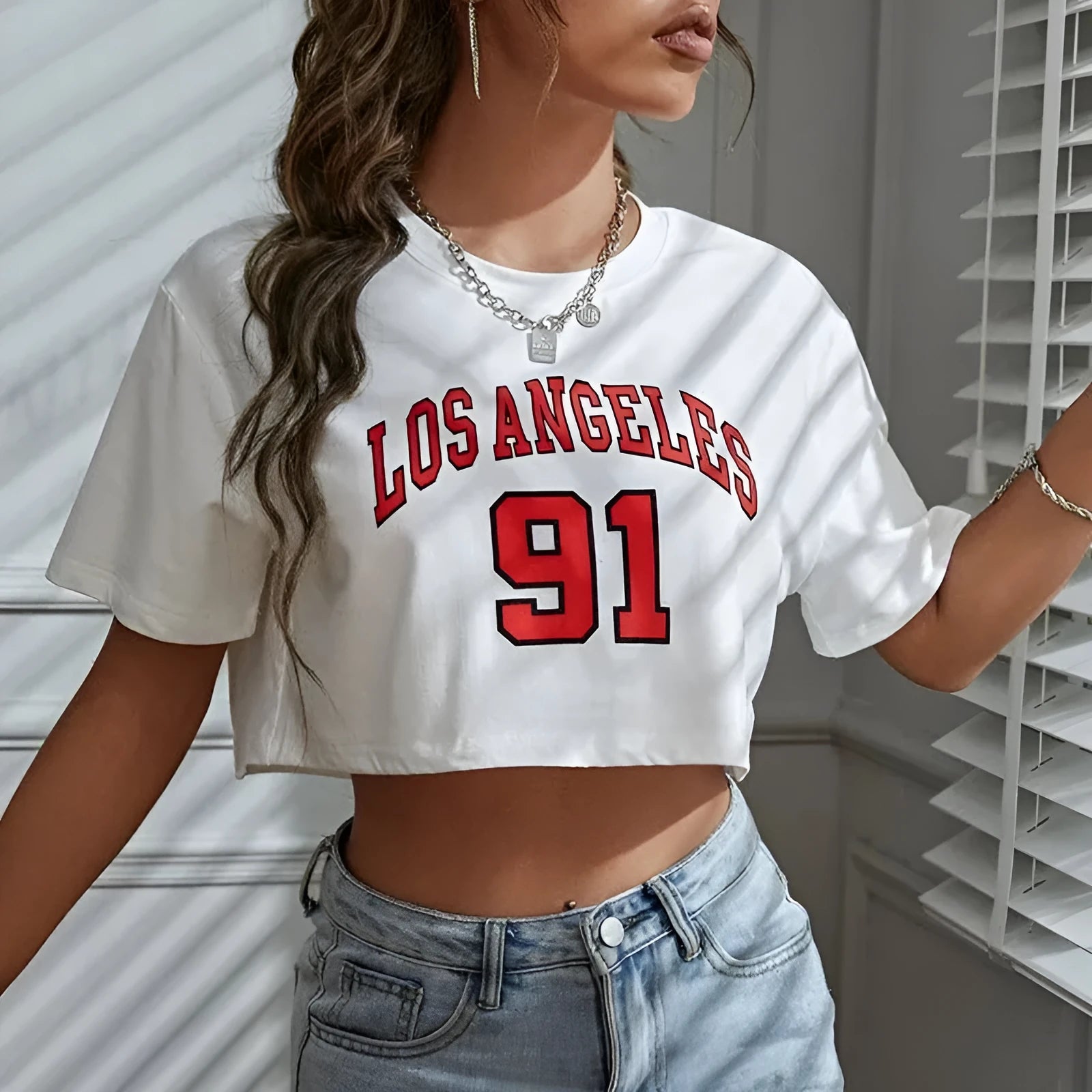 Black personalised '23 Letters' printed cotton T-shirt with loose fit and exposed navel style on a mannequin.