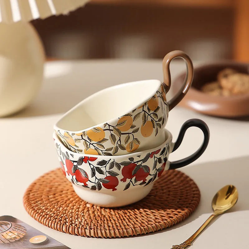 Antique style ceramic coffee cup and saucer with 210ml capacity, shown in black pomegranate and orange Citrofortunella design options.