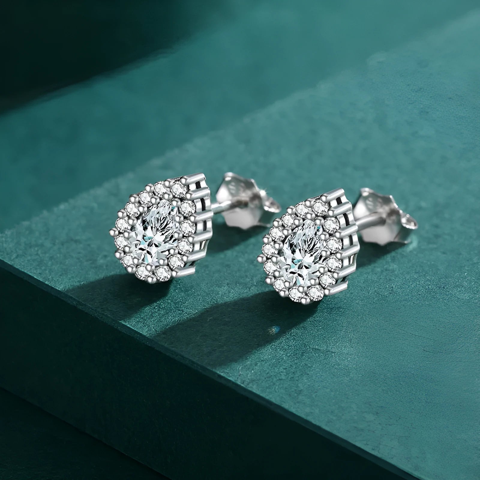 Close-up of a women's sterling silver drop ear stud with a polished finish and diamond-treated detail.