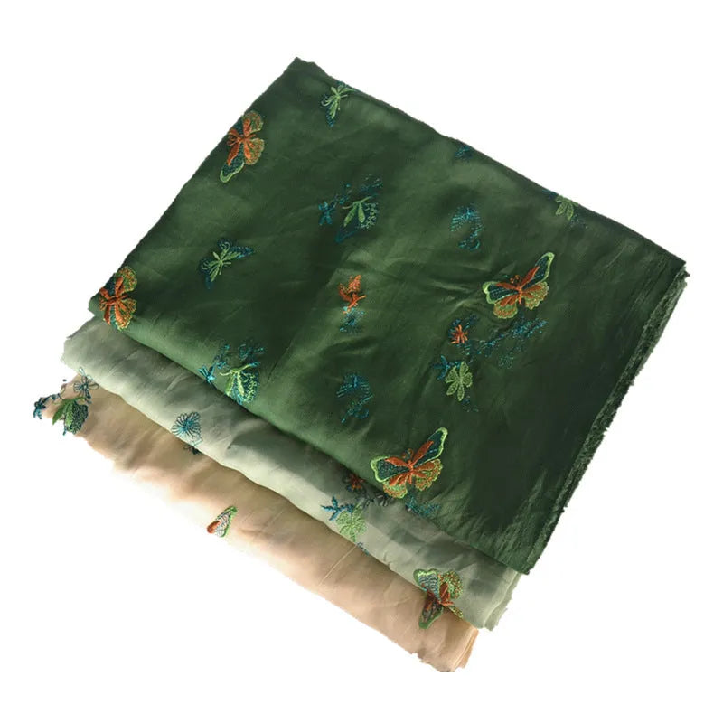 A piece of pure ramie embroidery fabric in a grass green colour, showing its woven texture.