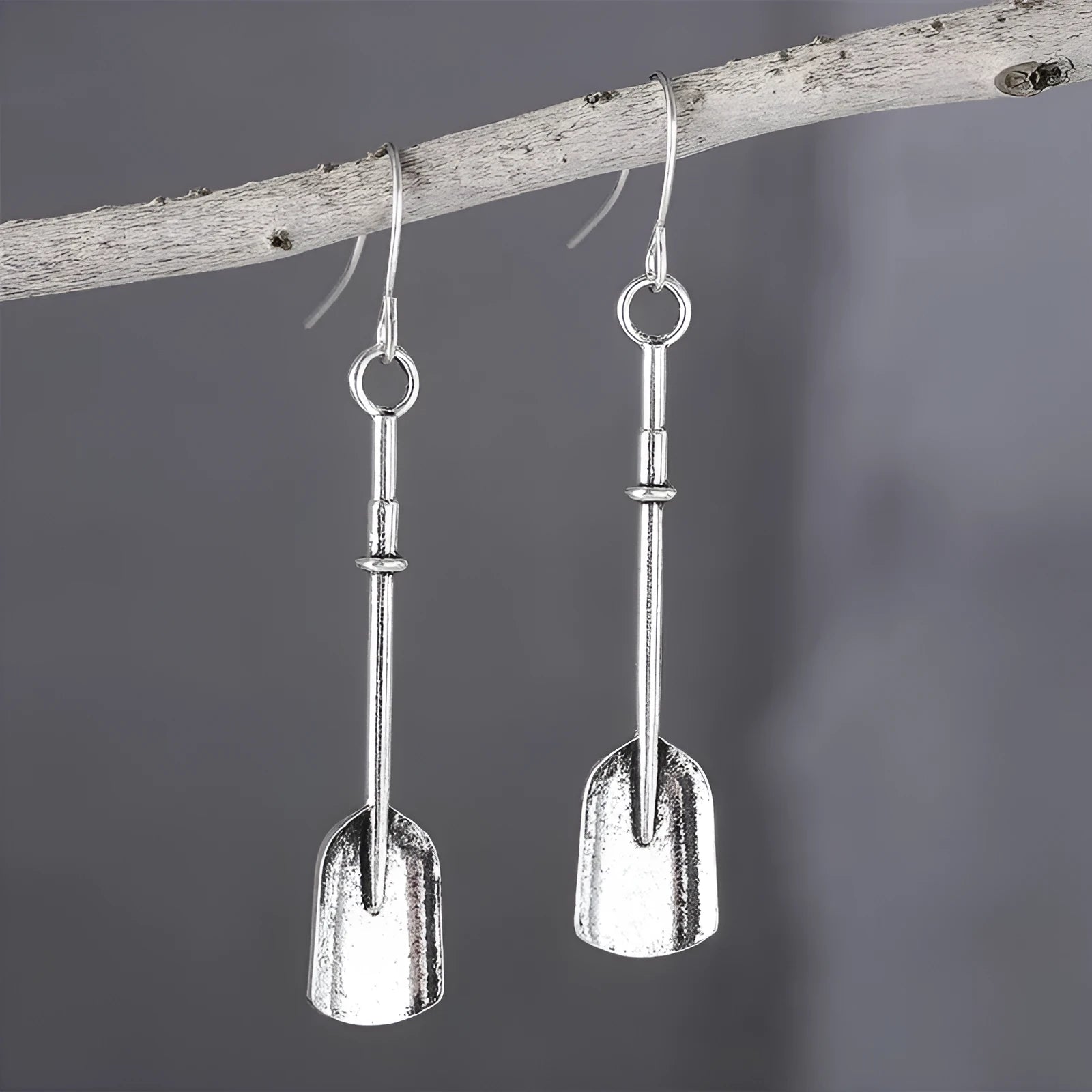 Long antique silver shovel-shaped drop earrings with a geometric retro design.