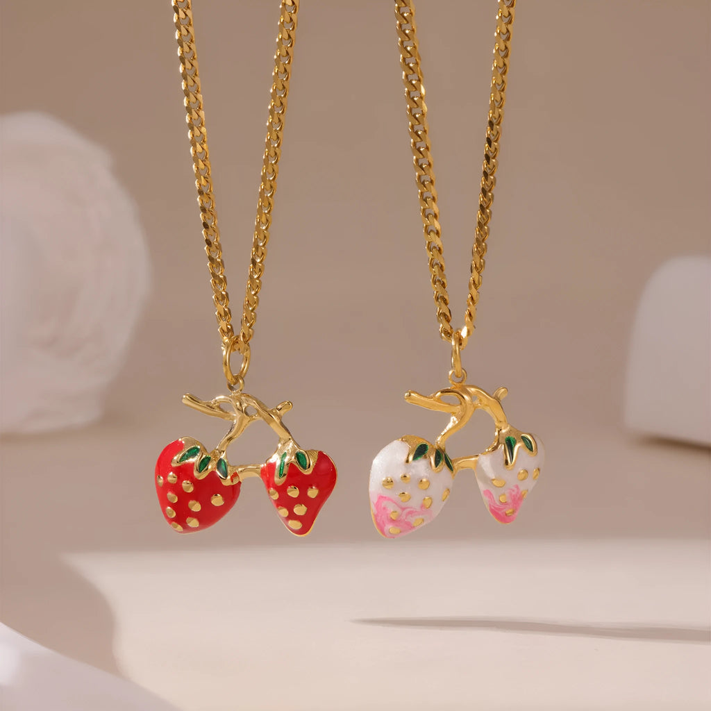 A women's necklace with a detailed strawberry-shaped alloy pendant on a stainless steel chain, shown in red and white gradient colour options.
