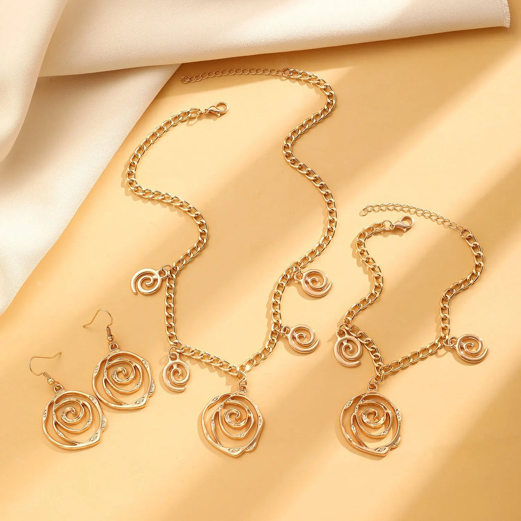 Spiral donut design jewellery set with necklace, bracelet and ear hooks in gold or silver finish
