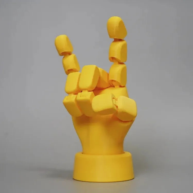 Yellow movable joint hand ornament made of PLA plastic for decoration.