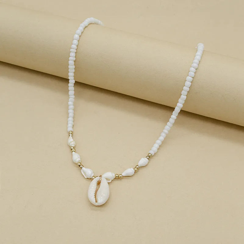 White electroplated conch shell pendant necklace on a regular chain for women.