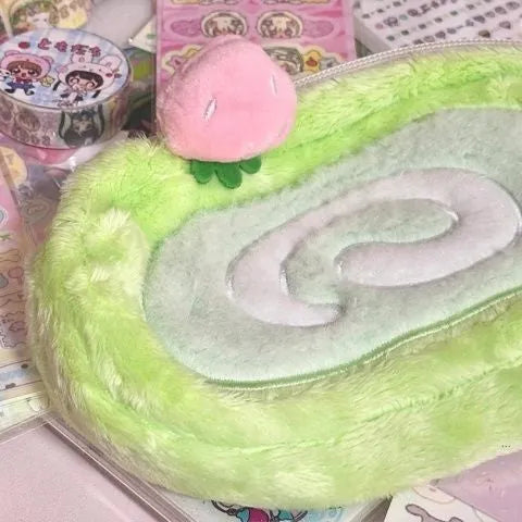 Honeydew roll plush velvet pencil case in Swiss roll cake colour on a desk.