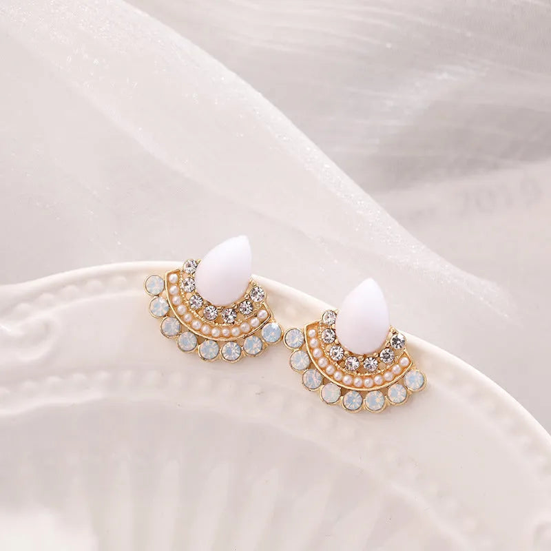 Retro silver geometric fan-shaped drop earrings with rhinestone and opal-style details.