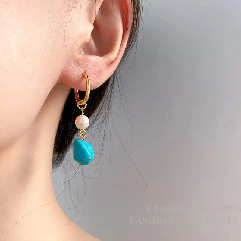 A pair of long and a pair of short geometric copper ear clips with turquoise and cultured pearls.
