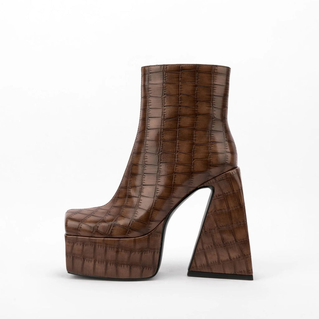 A pair of women's super high heel ankle boots in a solid colour with an artificial PU upper.