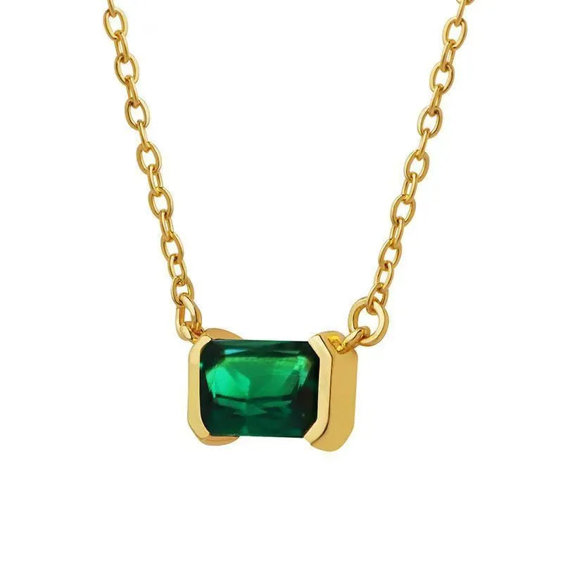 Gold geometric quadrilateral pendant necklace with inlaid cubic zirconia stones on a matching chain.