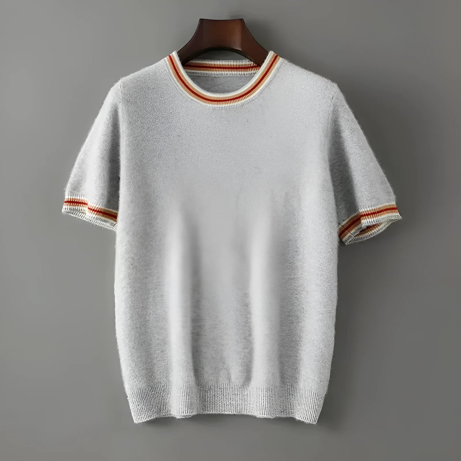 A man's short sleeve pure wool sweater with a round neck, shown in a neutral colour.