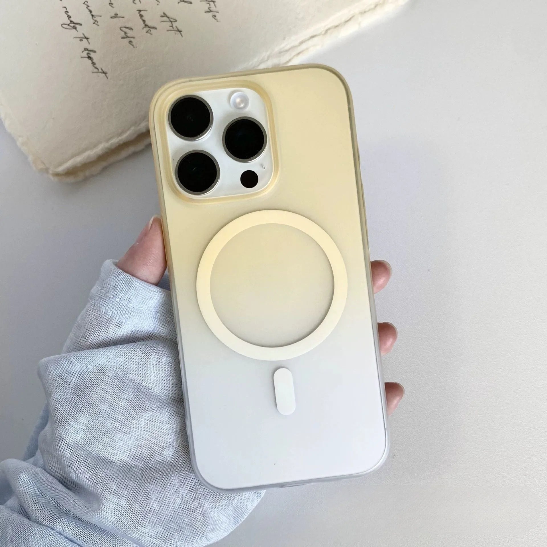 Gradient colour frosted magnetic suction protective case for iPhone on a white background.