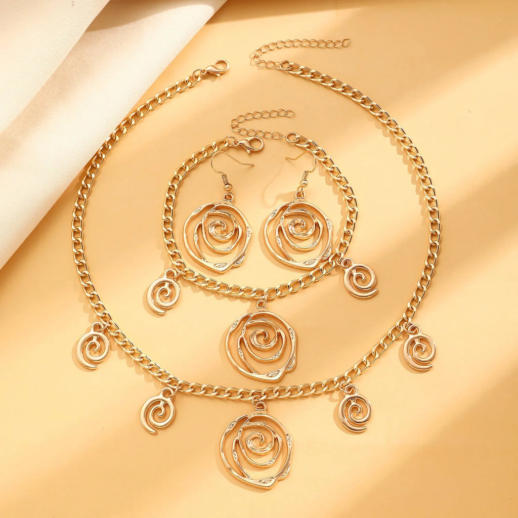 Spiral donut design jewellery set with necklace, bracelet and ear hooks in gold or silver finish