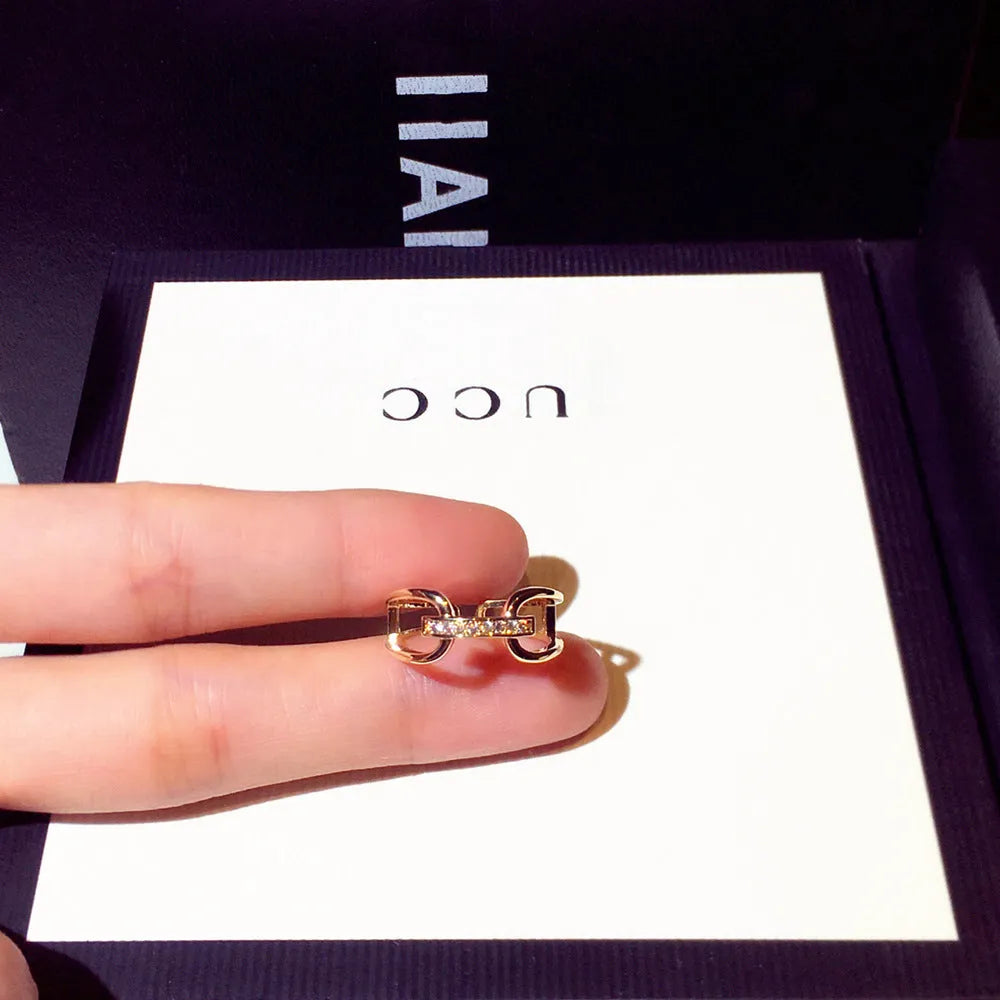 Golden copper geometric women's ring with inlaid zircon stone in Han style.