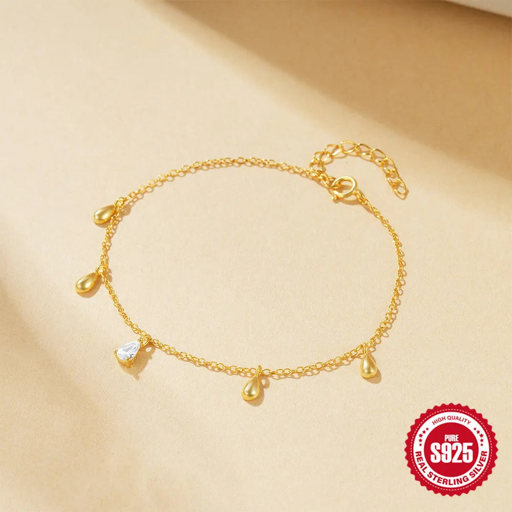 Gold tone S925 sterling silver bracelet with a geometric water drop diamond pendant charm.