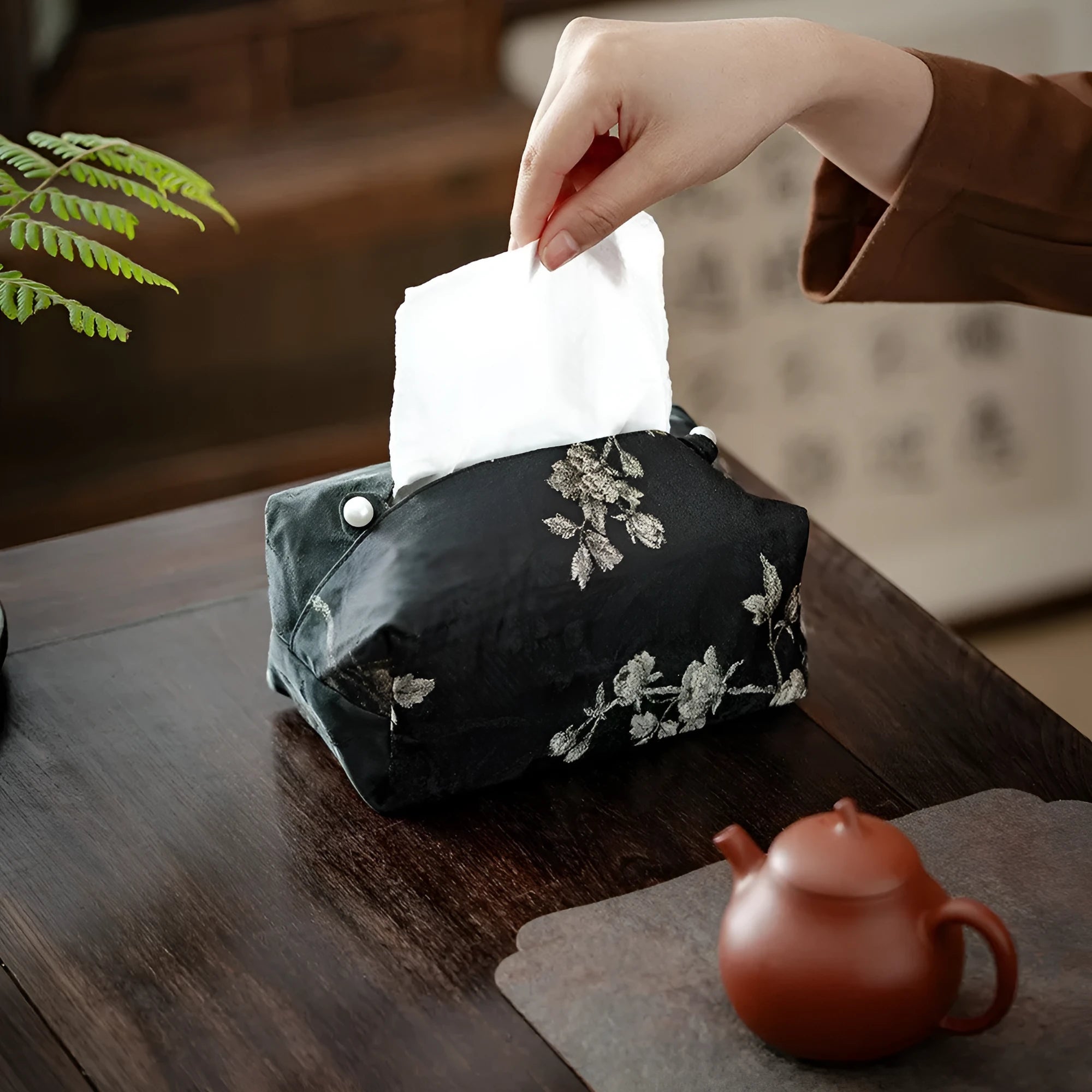 White Chinese brocade tissue box cover with embroidered plum blossoms, showing pearl buckle and plain opening options.