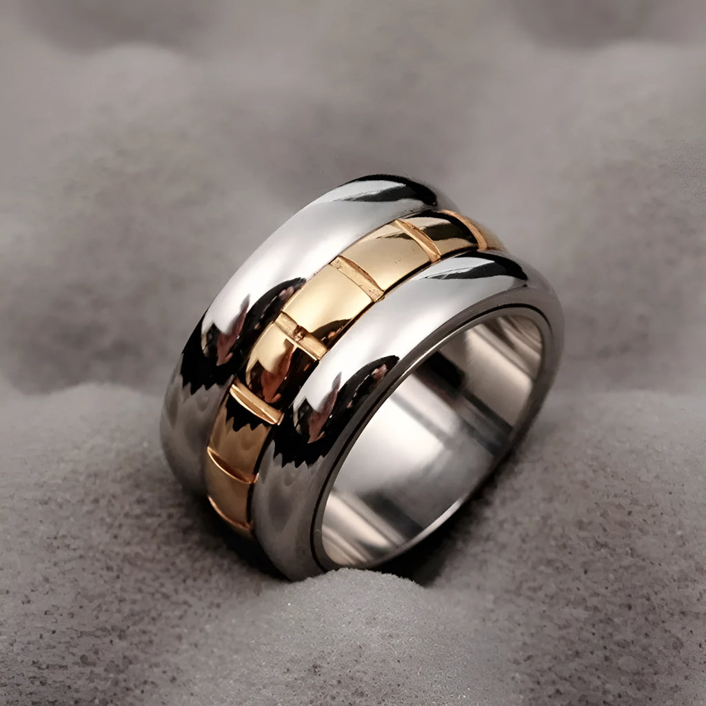 Gold titanium steel ultra-wide knuckle ring with a rotatable tail, shown on a finger.