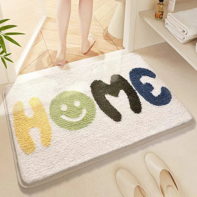 Square rainbow print floor mat with sky and sea colours on a flat, light-coloured polyester fibre pile.