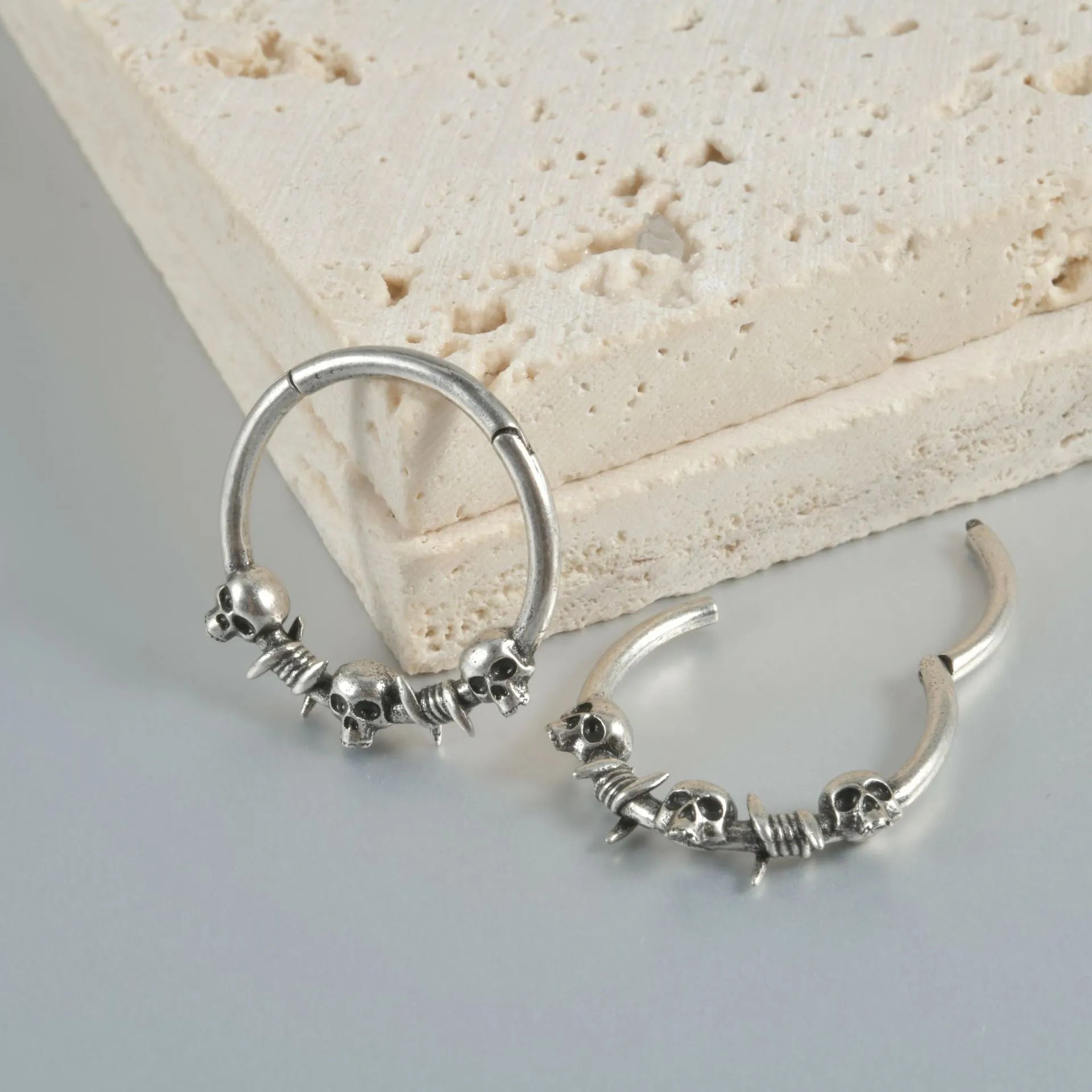 Copper punk earring with antique silver ghost head charm.