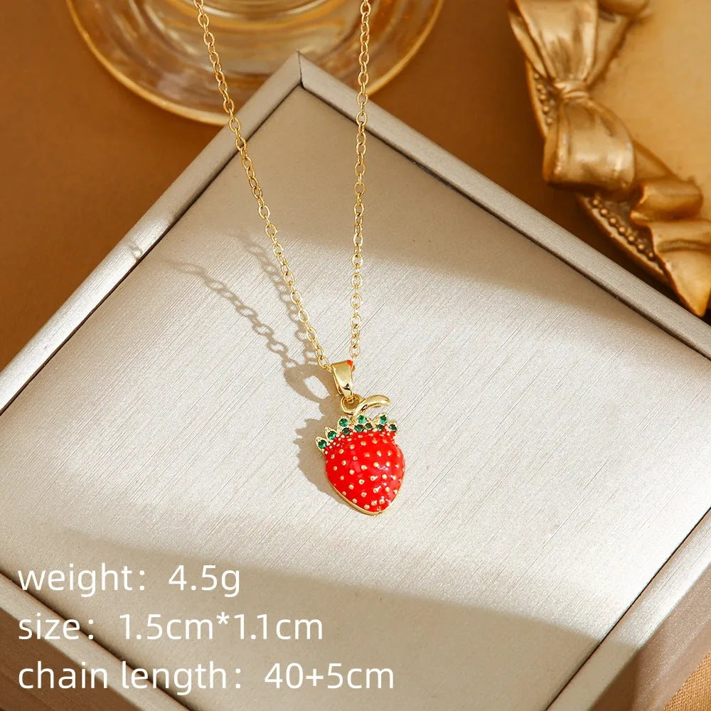 Delicate red fruit charm necklace on a titanium steel O-ring chain, showing gold and steel colour options.