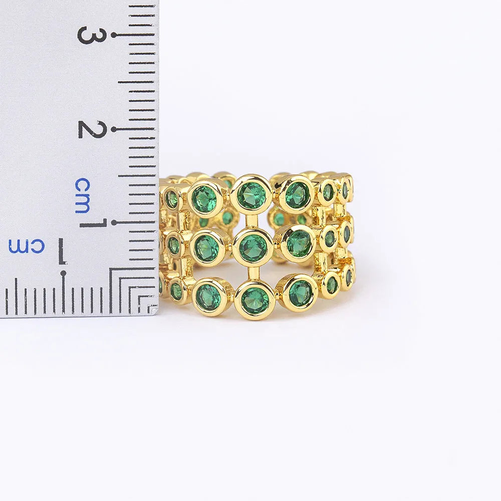 Copper ring with gold plating and green zircon stones on wide band