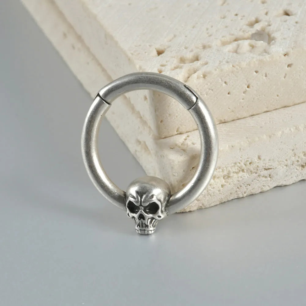 Copper punk earring with antique silver ghost head charm.