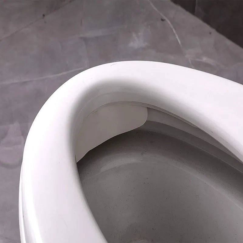 White PVC urine blocking board placed on toilet seat for children's splash prevention