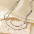Gold geometric double-layer twist necklace on adjustable snake chain, shown at 40cm length.