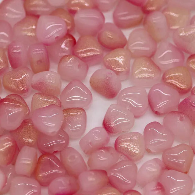 Twenty transparent Czech glass love heart spacer beads in assorted colours including aurora purple and peach gold.