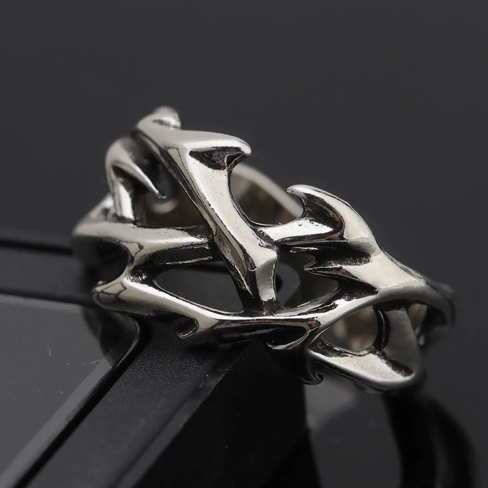 Copper men's ring with geometric thorn and flower design on an adjustable band