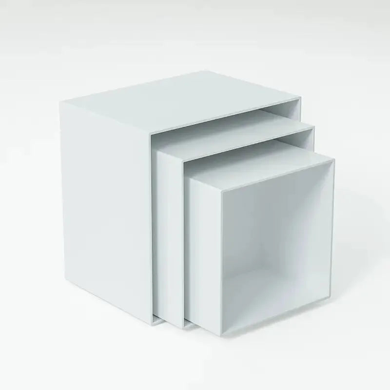 Set of six white plastic stacking cubes for displaying cakes and desserts on a table.