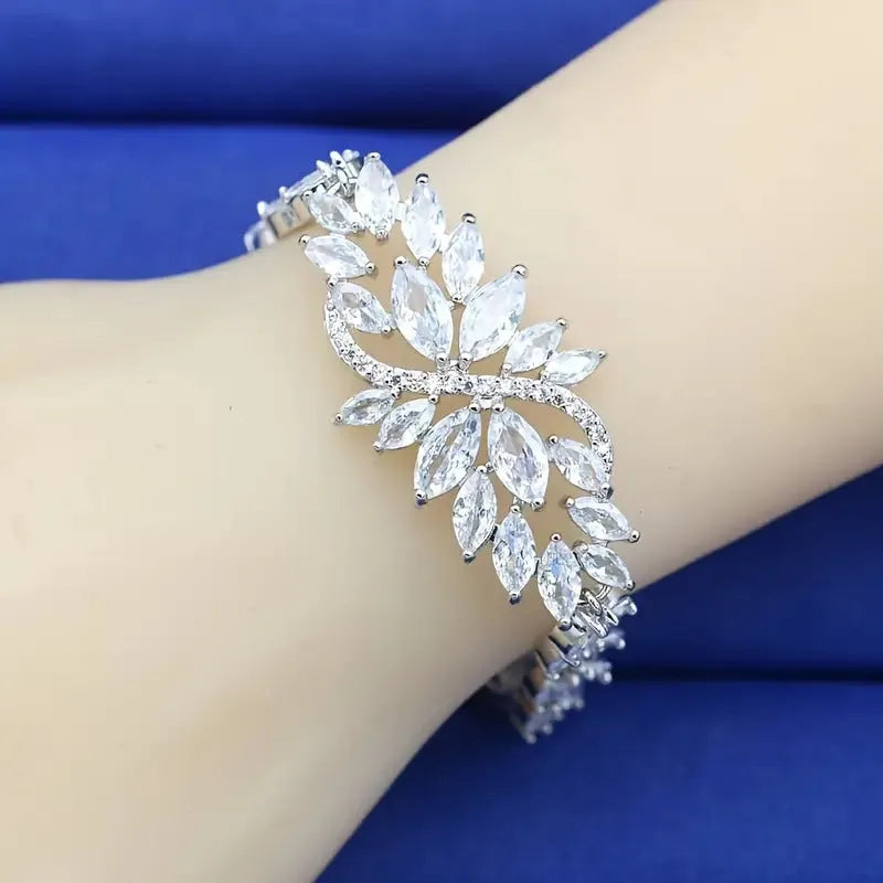 Gold electroplated copper bracelet with coloured zircon stones and ice flower detail.
