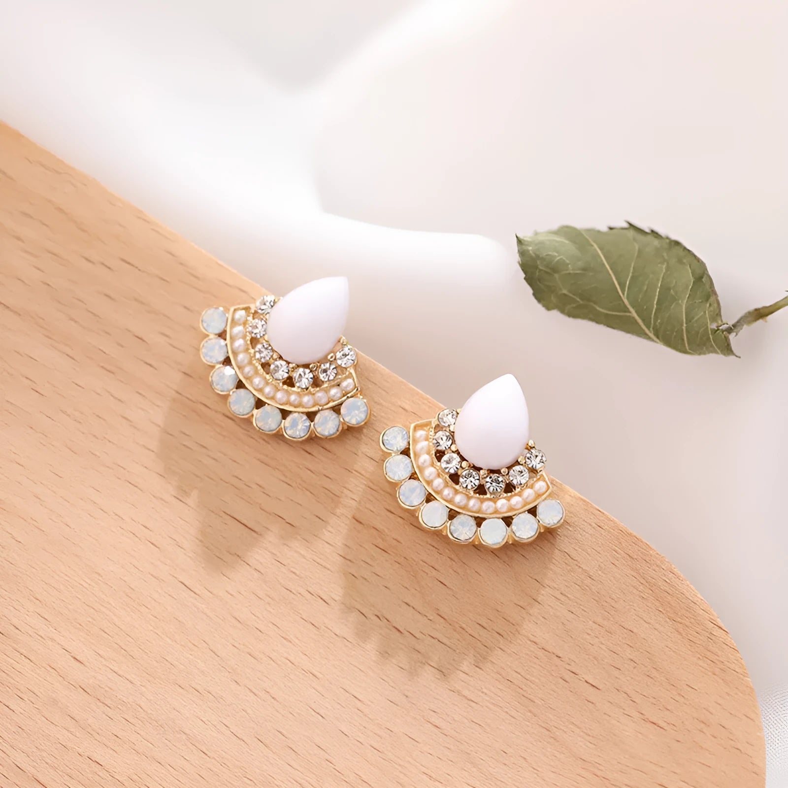 Retro silver geometric fan-shaped drop earrings with rhinestone and opal-style details.